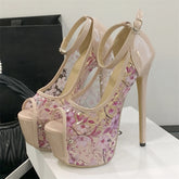 Floral high-heeled shoes on a white surface with a neutral background